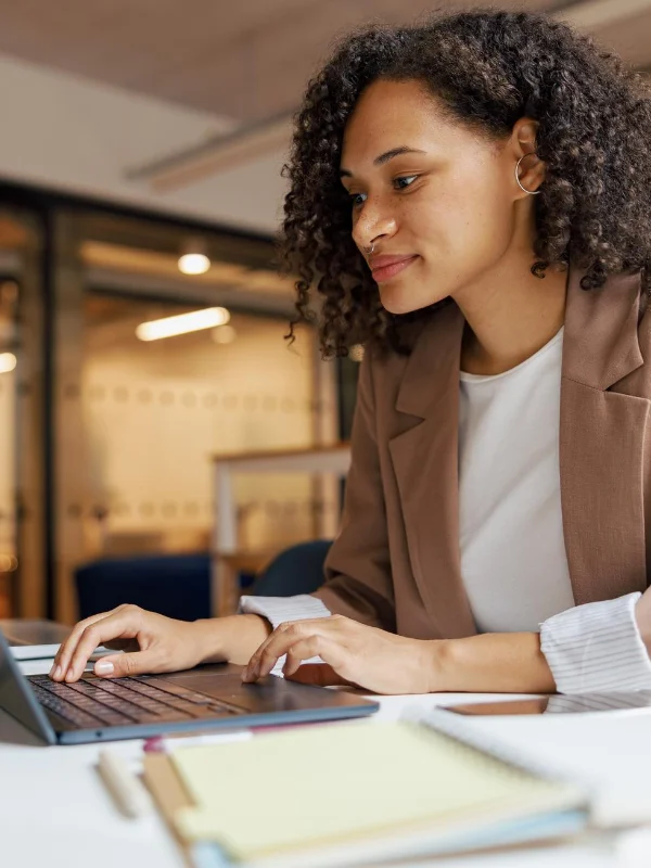 A professional discovering key topics of the Finance & Supply Chain Management Developer Learning Journey on a laptop indoors
