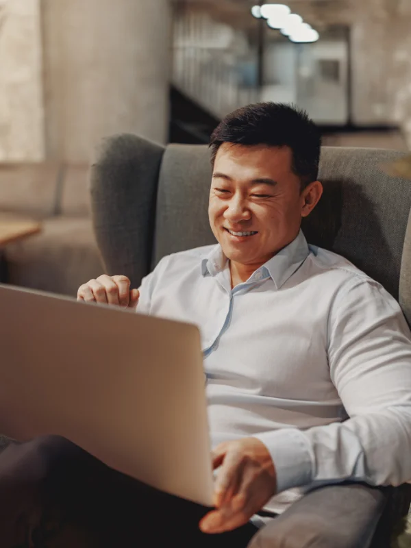 A professional discovering key topics of the Power Platform Learning Journey on a laptop indoors