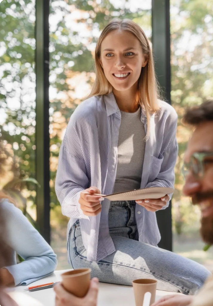 Woman sitting on desk eating